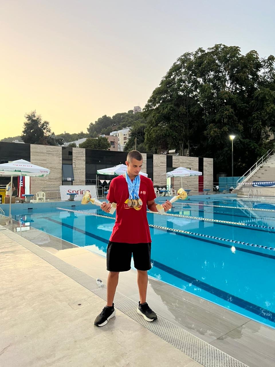 Klint Hoxha holding two national championship trophies, National Championship 2026